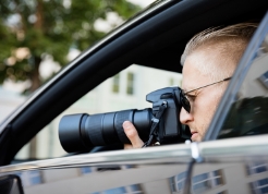 private-investigator-taking-photo-from-car